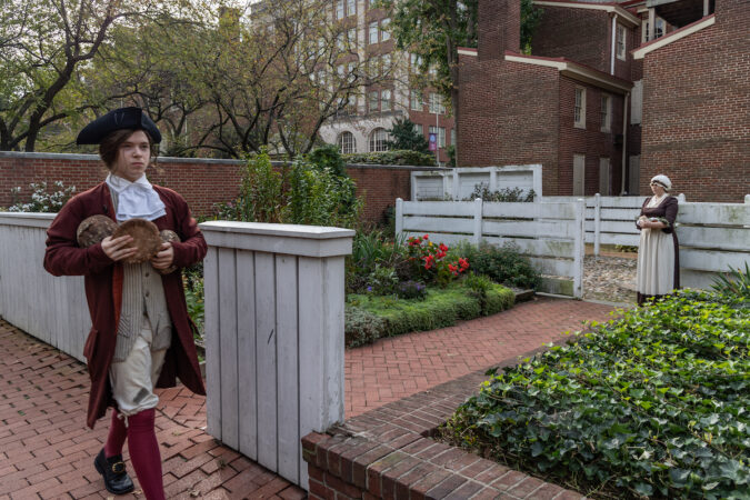 A young Benjamin Franklin encounters his future wife, Deborah Read Franklin, during a re-enactment