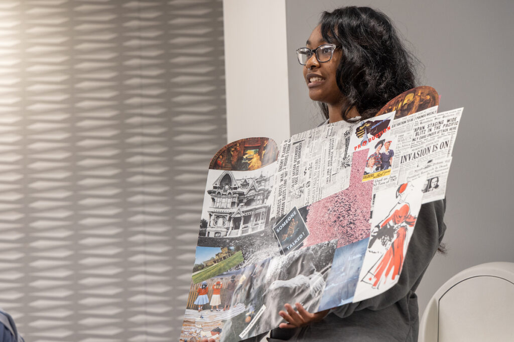 Chrisma Tucker, a 17-year-old student at Revolution School, explains her collage reflecting on the majority white, two-parent households in her neighborhood during a collaborative art project at the University of the Arts on Oct. 10, 2023