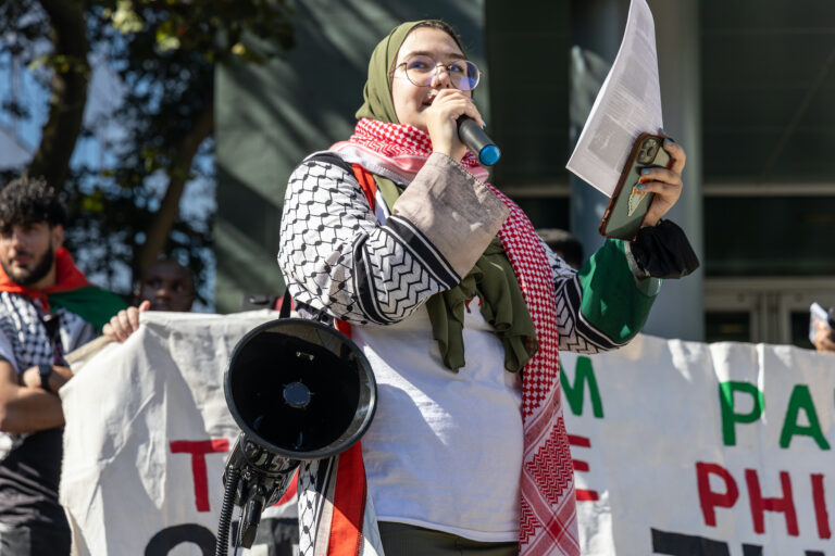 Nada speaking into a microphone at the rally