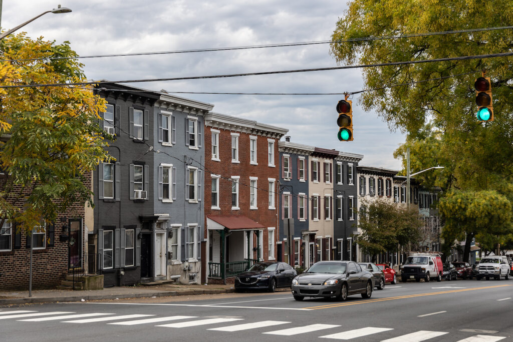 Rowhomes in Wilmington, Del. (Kimberly Paynter/WHYY) Rowhouses in Wilmington on a street.
