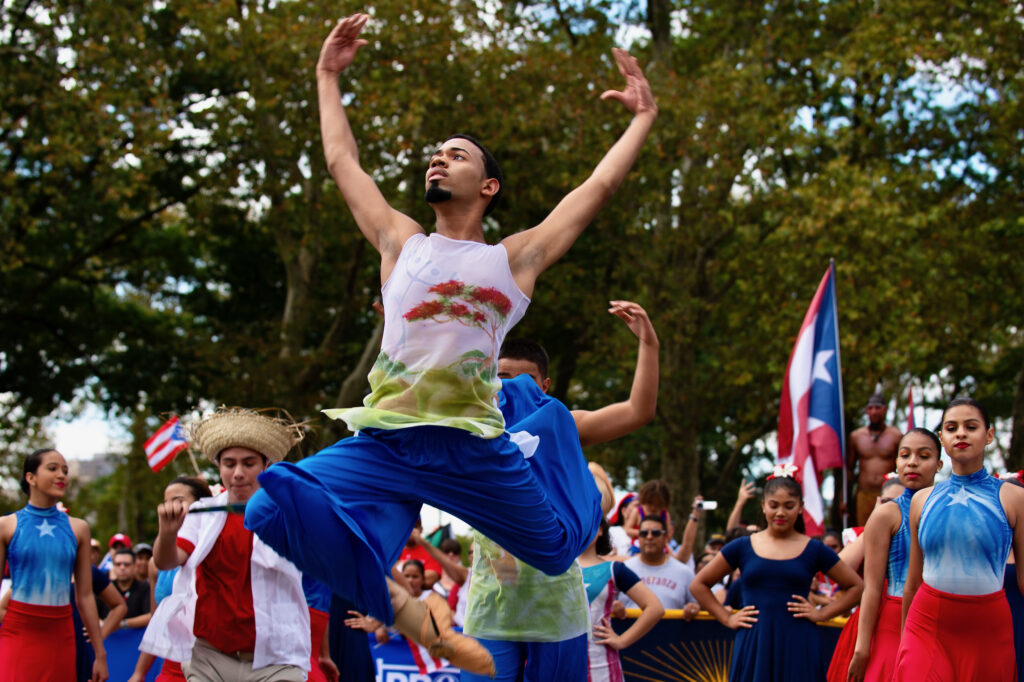 2019 09 29-k bethel-eric blanco-philadelphia-puerto rican day parade esperanza dancers Eric Blanco leaps through the air during a dance performance as part of the Puerto Rican Day Parade