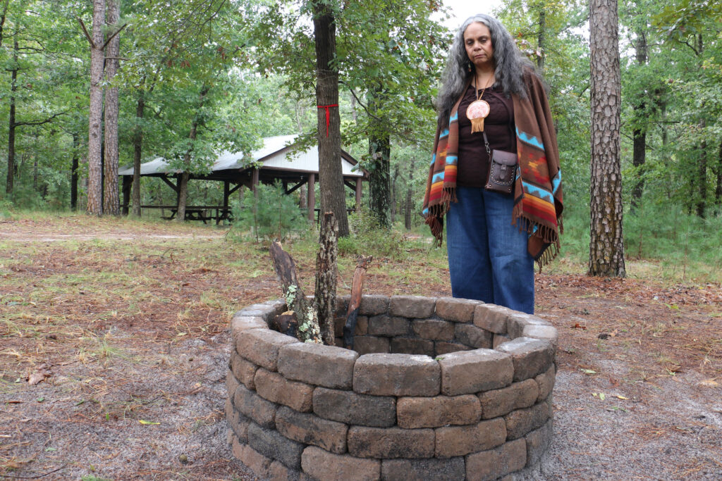 Tyrese Gould Jacinto looks into a fire circle