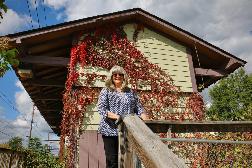 Bernadette Dougherty poses for a photo outside of the Ambler Freight House