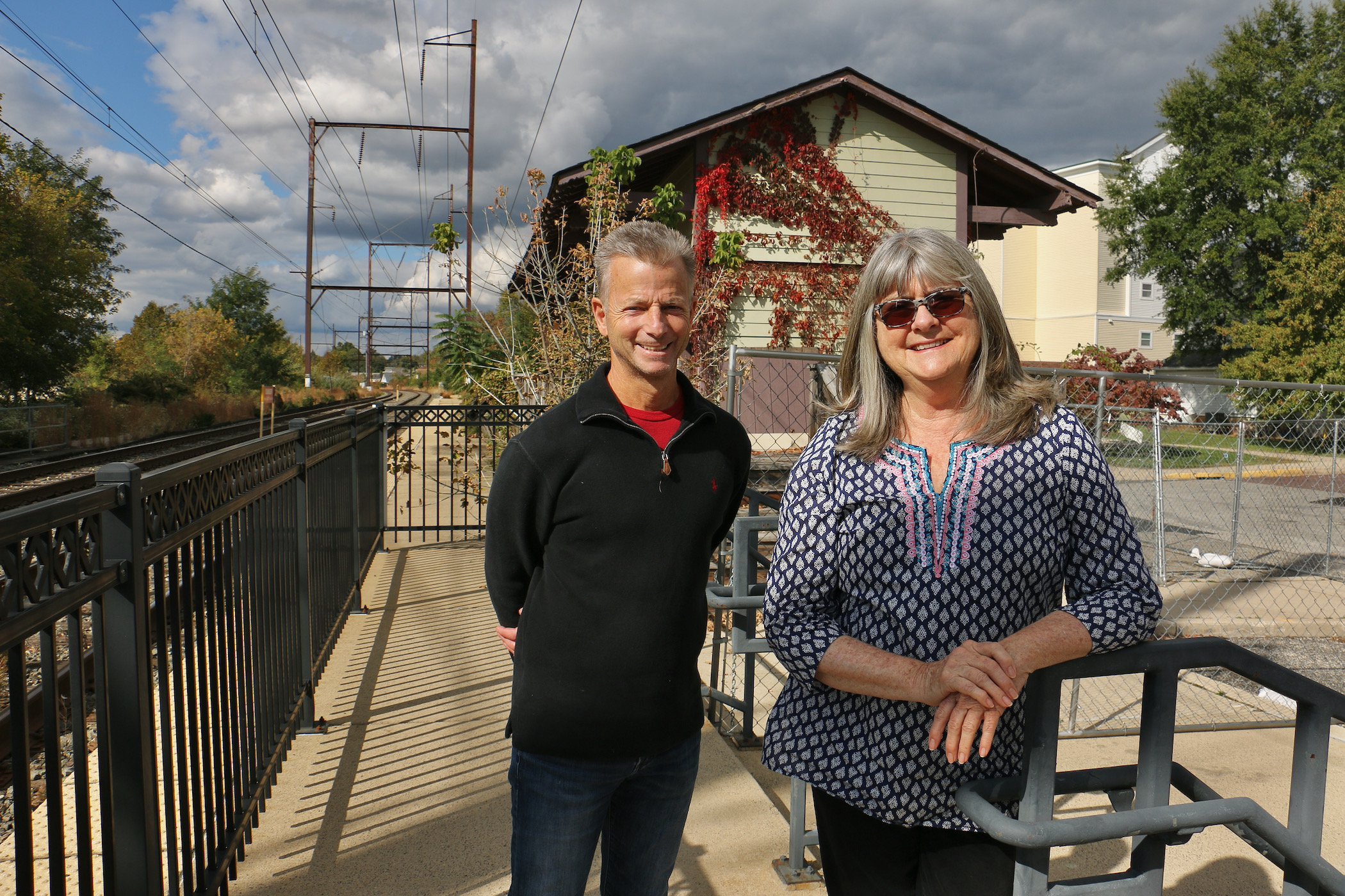 Joe Langella, vice president of the Wissahickon Valley Historical Society, and Bernadette Dougherty pose beside the Ambler Freight Station