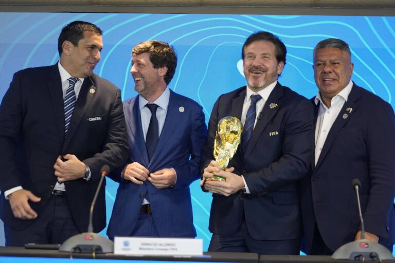 Paraguay's Soccer Association President Robert Harrison (left) FIFA delegate Ignacio Alonso, center, Conmebol President Alejandro Dominguez (third from left) and Conmebol Vice President Claudio Tapia stand after announcing host countries for the World Cup soccer tournament in Luque, Paraguay, Wednesday, Oct. 4, 2023.