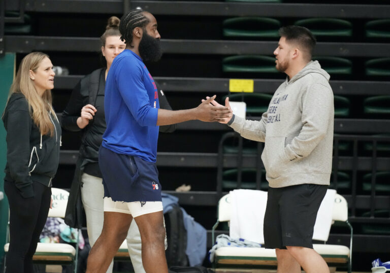 Philadelphia 76ers guard James Harden (left) greets Brandon Chinn, 76ers Director of Basketball Communications, during the NBA basketball team's practice on Thursday, Oct. 5, 2023, in Fort Collins, Colo.