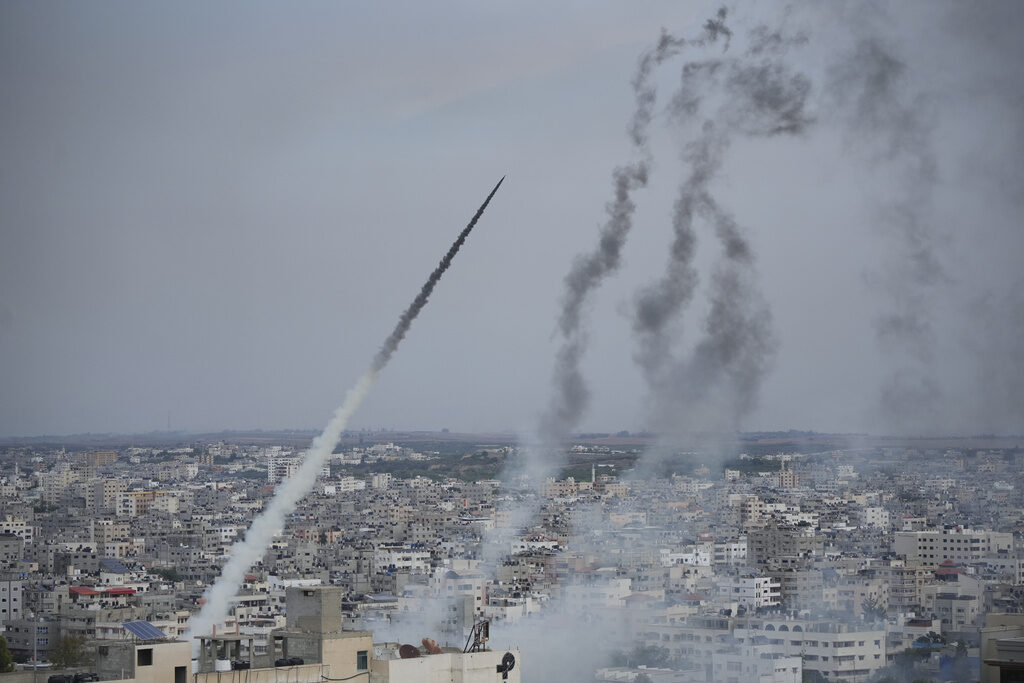 Israel Palestinians Rockets are seen in the air, after being launched across buildings