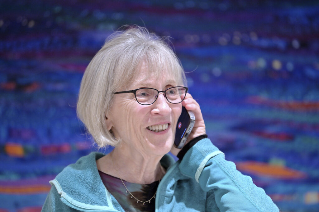 Nobel Economics Claudia Goldin speaks to a reporter on the phone in her home in Cambridge, Mass. after learning that she received the Nobel Prize in Economics, Monday, Oct. 9, 2023.