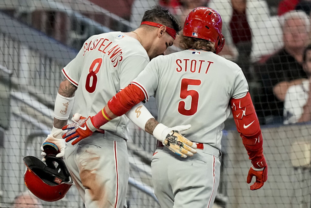 NLDS Philles Braves Baseball Philadelphia Phillies' Nick Castellanos (8) celebrates scoring a run with Bryson Stott (5) in the fifth inning of Game 2 of a baseball NL Division Series against the Atlanta Braves, Monday, Oct. 9, 2023, in Atlanta.