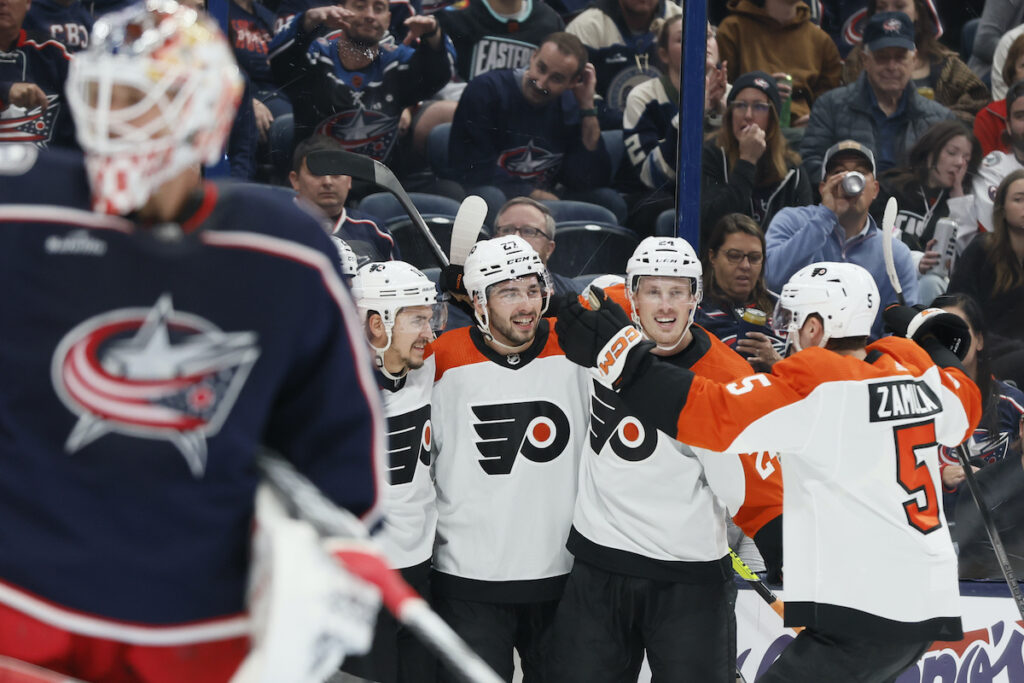 Elvis Merzlikins Philadelphia Flyers celebrate a goal against Columbus Blue Jackets' Elvis Merzlikins (foreground) during the first period of an NHL hockey game Thursday, Oct. 12, 2023, in Columbus, Ohio.