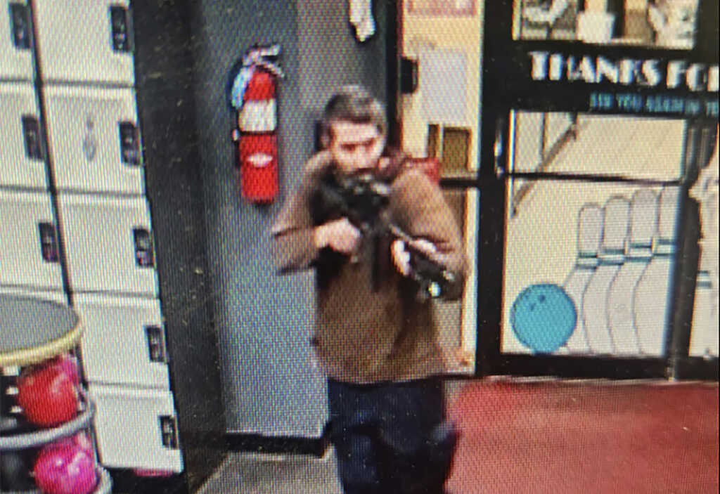 A person with a gun on security footage