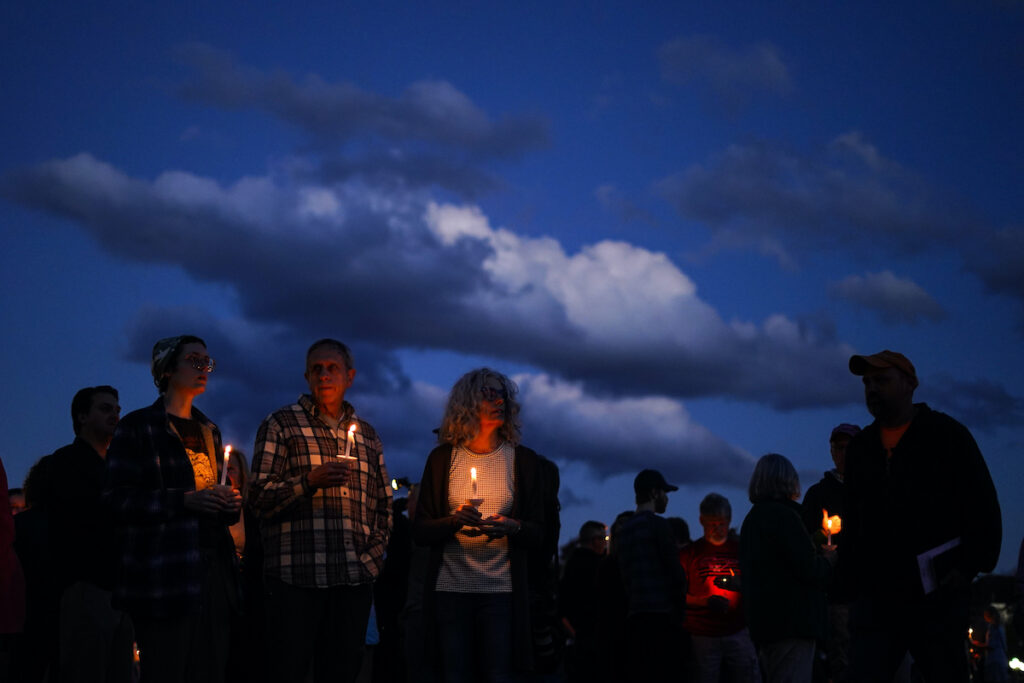 Maine Shooting People gather at a vigil in Lisbon Falls, Maine, for victims of the week's mass shootings, Saturday, Oct. 28, 2023.
