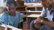 In this still from "Ariel Phenomenon," a student draws a picture of what she witnessed on the day of the UFO encounter while psychiatrist John Mack looks on. (Courtesy of John E. Mack Institute)