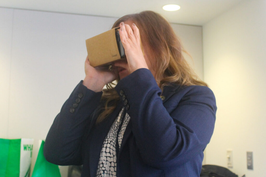 A volunteer looks into a VR viewer.