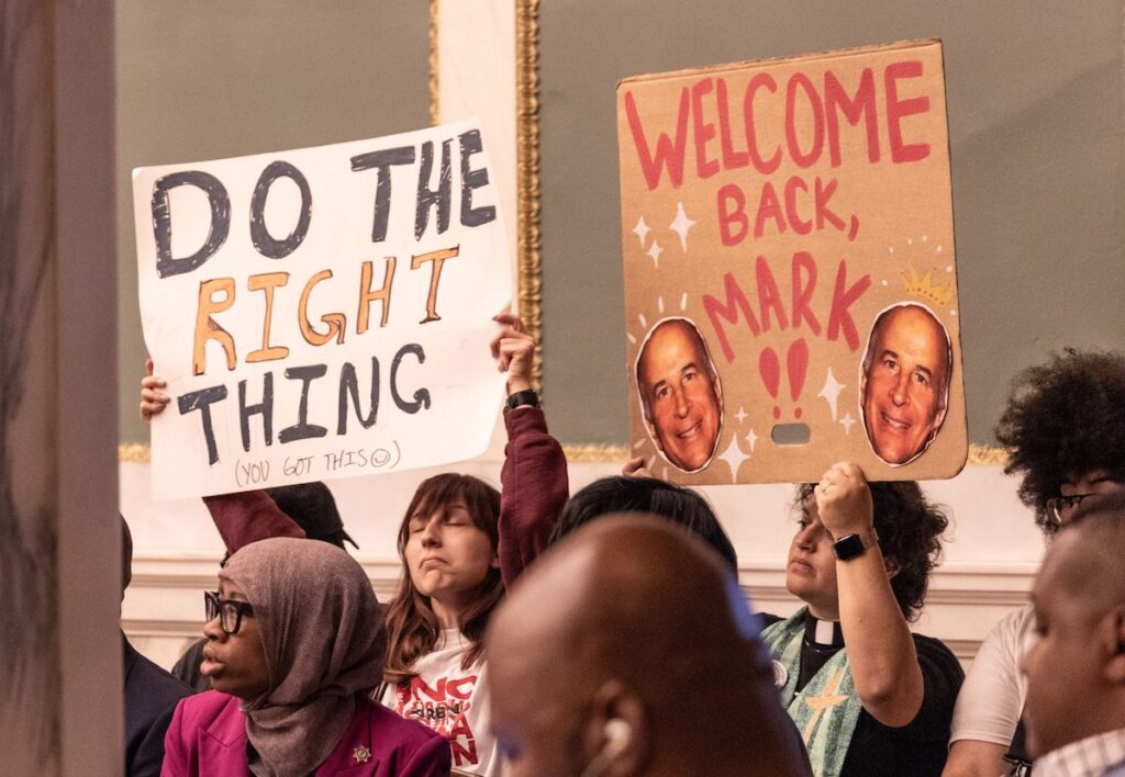 antiarena-protest-citycouncil-squilla-scaled Opponents of the proposed 76ers arena in Chinatown display signs in City Council chambers