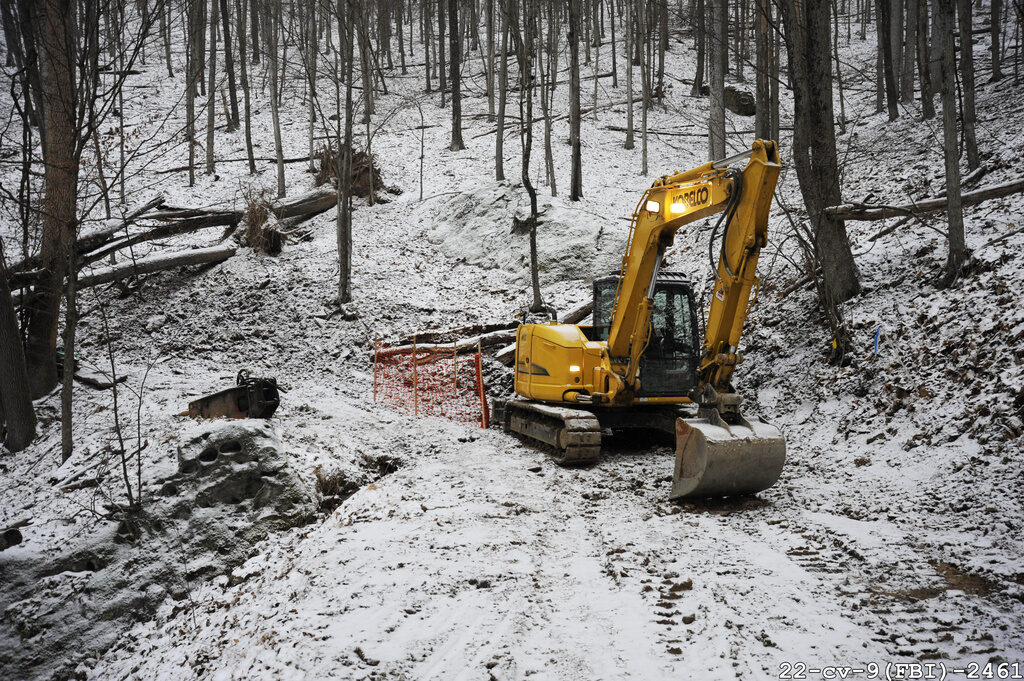 Civil War Gold-FBI Dig A digging construction machine in the woods
