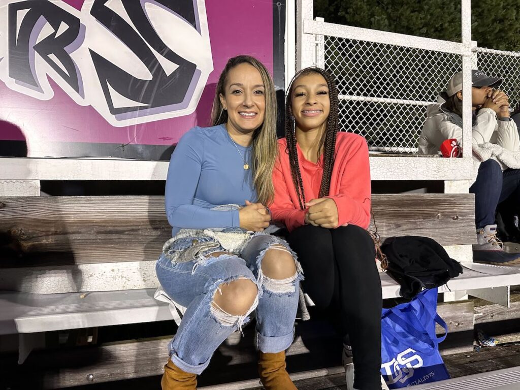 Family members cheer on Jordan Miller from the stands