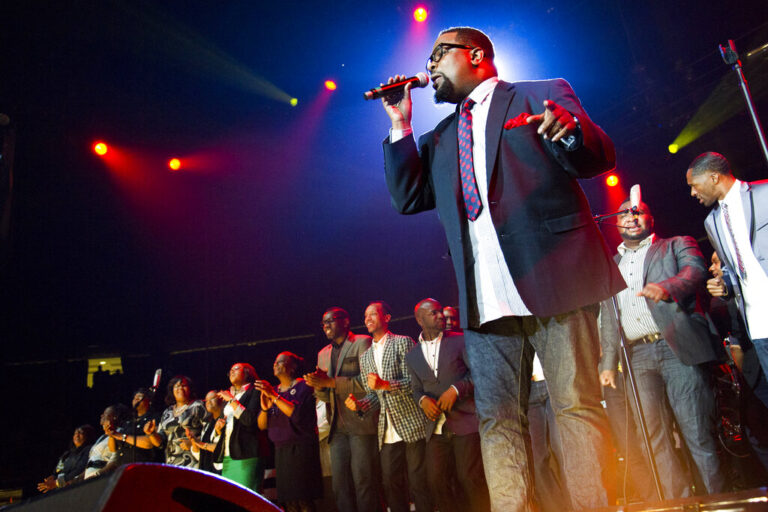 Hezekiah Walker sings with a group onstage