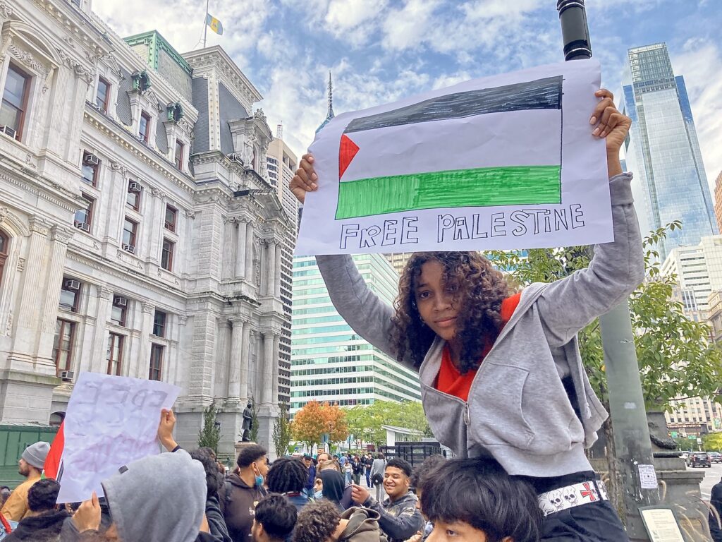 Protester holding up a sign at the pro-Palestine rally