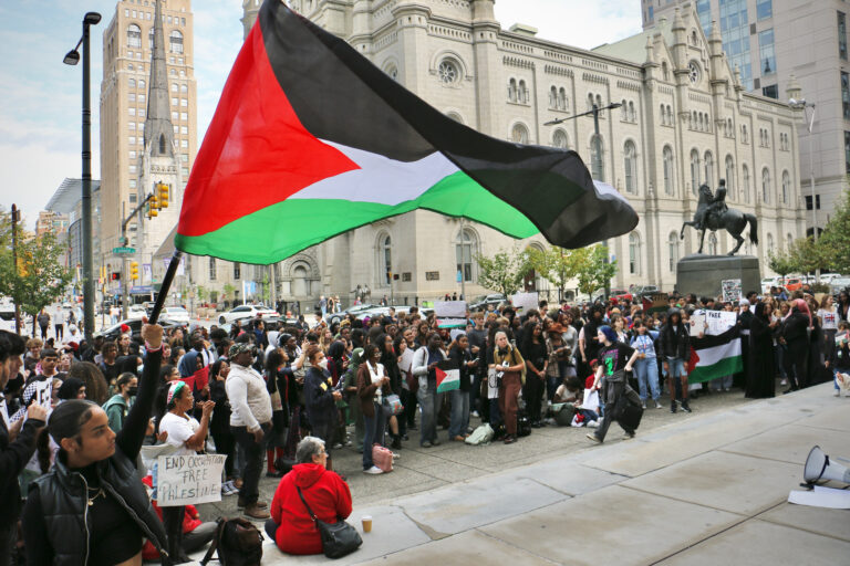 Palestinian flag being waived at a rally.