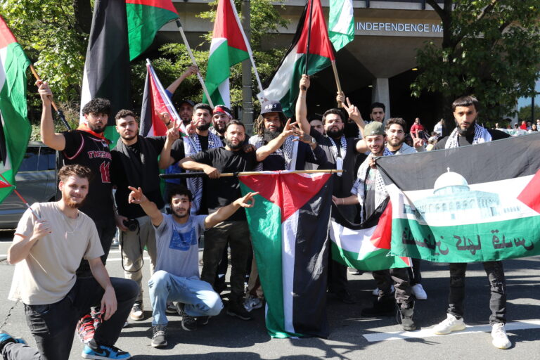 A group of Palestinian supporters pose with the Palestinian flag