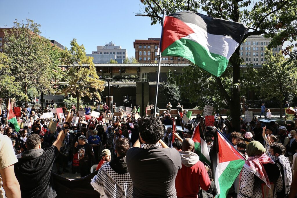 israel-palestine-whyy-protest-e-lee-2023-10-12-10 A person waves a Palestinian flag at the rally