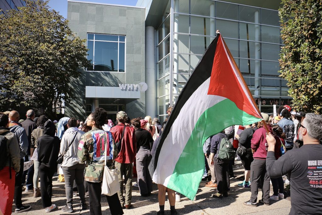 A man holds a Palestinian flag at a rally