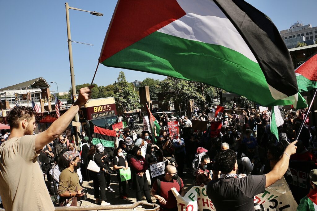 People waving Palestinian flags at the protest