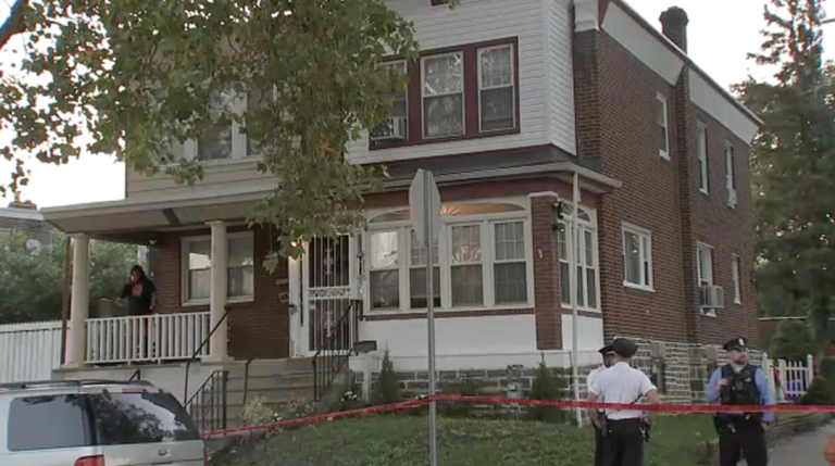 Police are seen outside a Lawncrest home following a triple homicide on Monday, Oct. 2, 2023.
