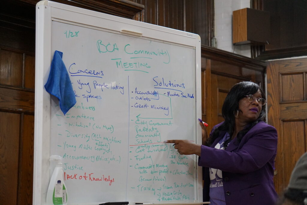 listen (4) Sajda ''Purple'' Blackwell writes down suggestions for solutions. (Sam Searles/WHYY)