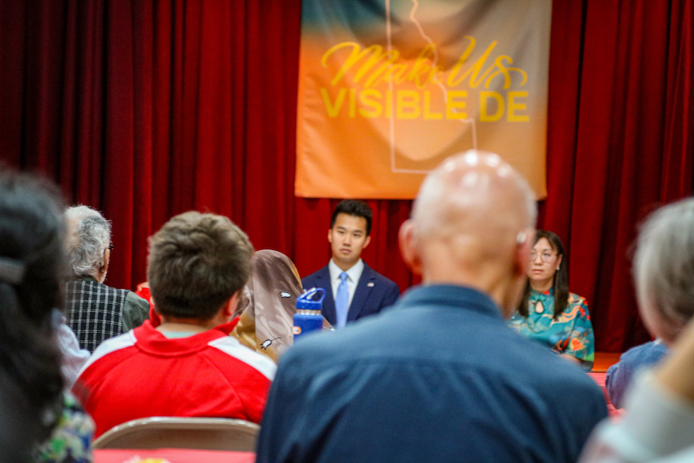Audience members look towards Devin Jiang and others onstage