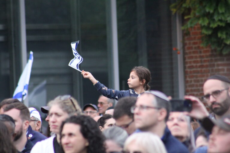 A child waving an Israeli flag at the rally
