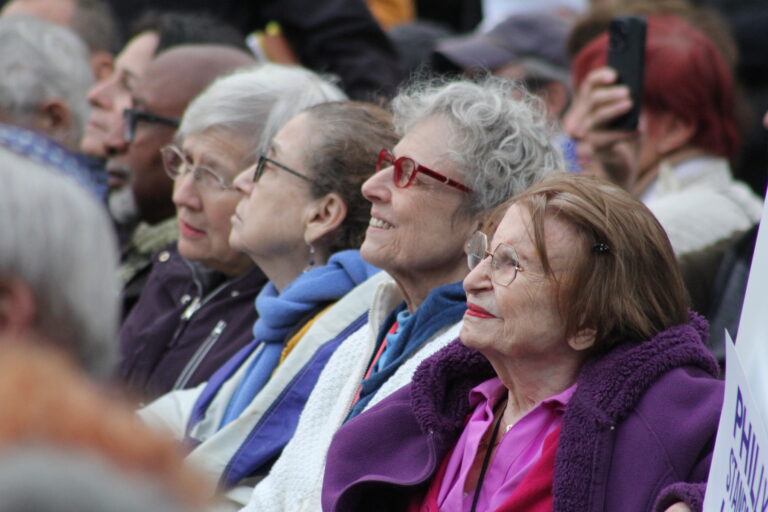 People in the crowd listening to speakers at the rally.