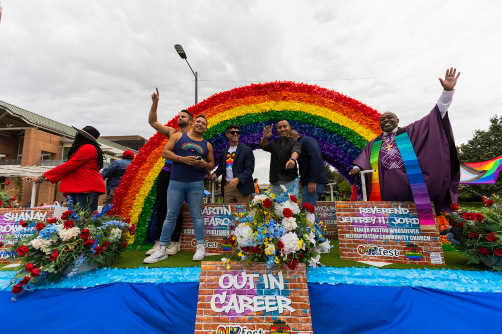 ourfest-pride-parade-02 Business and community leaders wave from the Out in Career float at the OURfest National Coming Out Parade. (Daisie Cardona for Billy Penn)