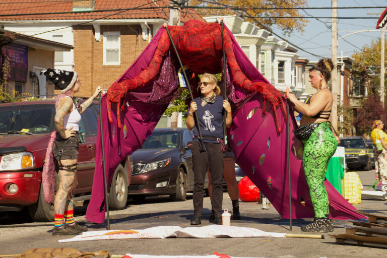 Participants set up a large puppet for the Spiral Q parade.