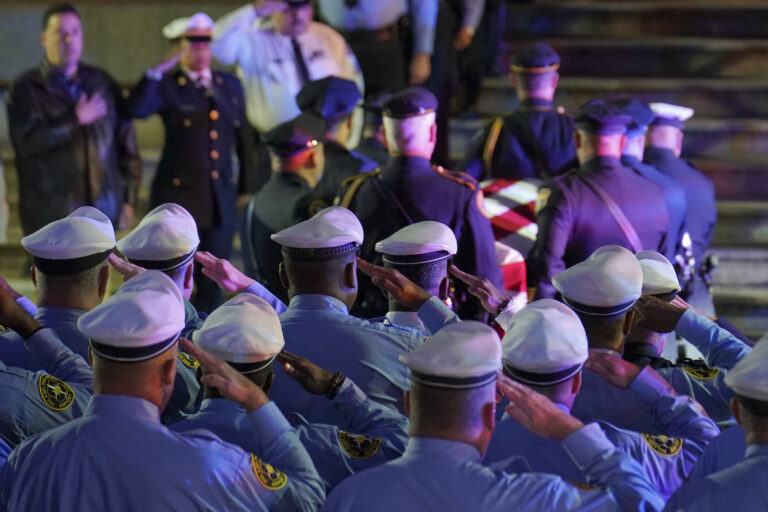 Officers salute as the casket arrives at the Cathedral Basilica of Saints Peter & Paul in Philadelphia for the funeral service for slain Police Officer Richard Mendez, Tuesday Oct. 24, 2023.