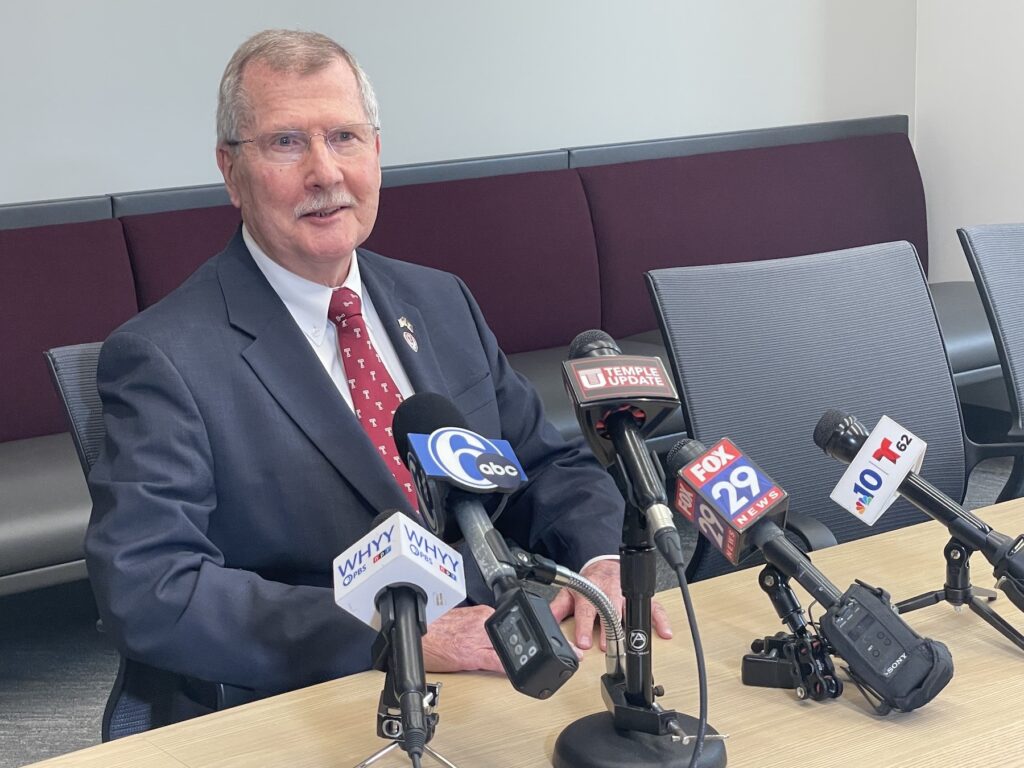 temple-president-richard-englert-burns-2023-10-19 Richard Englert sitting a table in front of several microphones
