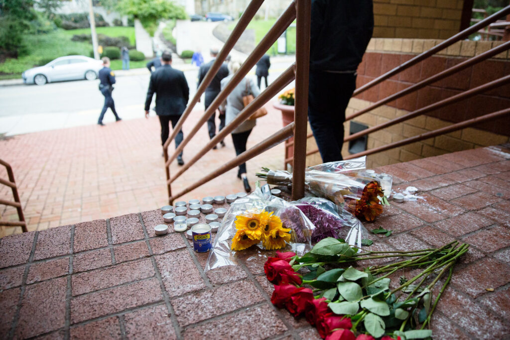 tree-of-life-pa-commonwealth-media-2023-10-27 flowers and candles on the steps of the building.