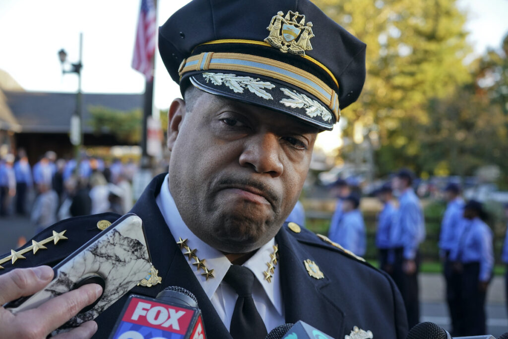 Interim Police Commissioner John Stanford speaks with news media