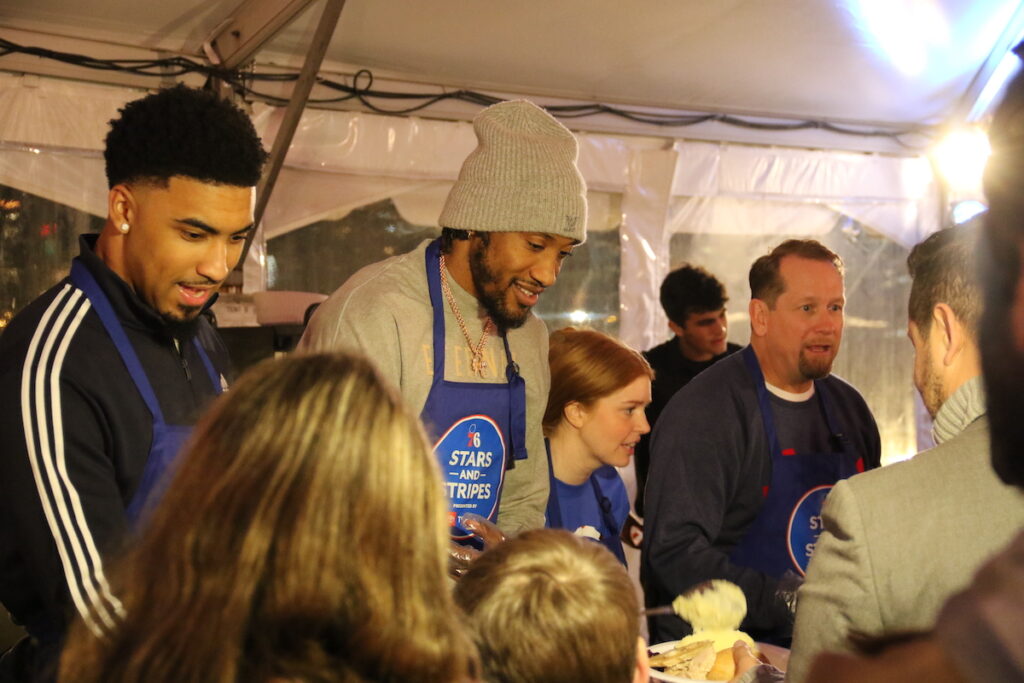 019A1168 Members of the Philadelphia 76ers served meals to military service members and veterans onboard the Battleship New Jersey on Monday. (Cory Sharber/WHYY)