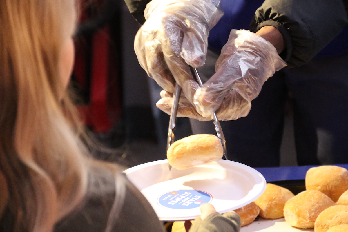 Members of the Philadelphia 76ers served meals to military service members and veterans onboard the Battleship New Jersey on Monday. (Cory Sharber/WHYY)