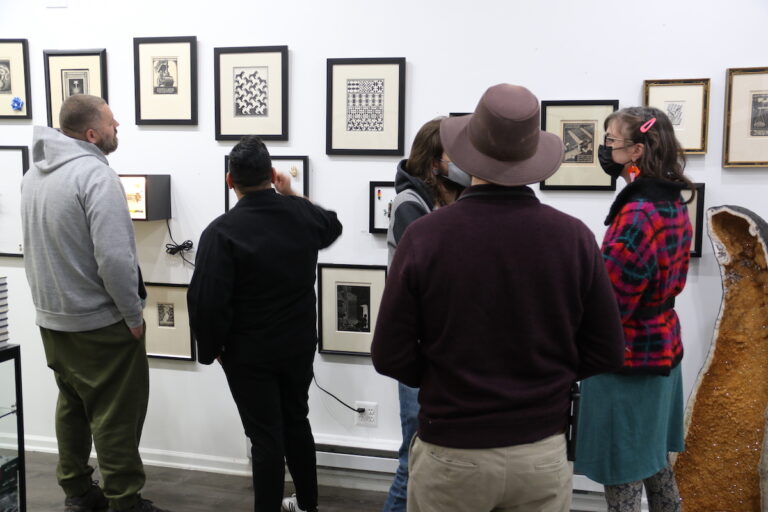 People came to the Front St. Gallery in Fishtown over the weekend to view original prints of M.C. Escher's work. (Cory Sharber/WHYY)