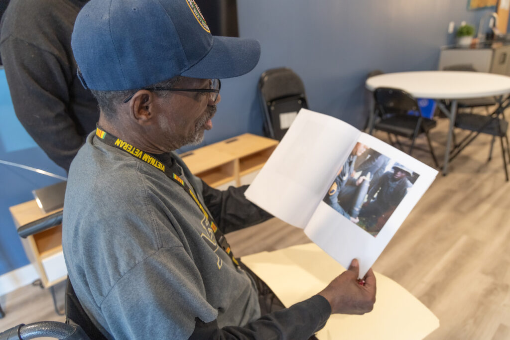 Leon Brantley looking at an old photo of himself.