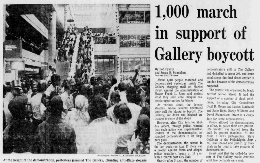 A newspaper clipping with a black-and-white photo has a headline that reads "1,000 march in support of Gallery boycott"