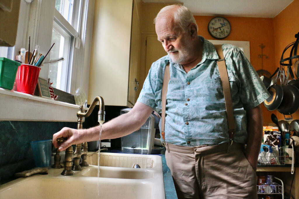 2023 06 06-e lee-douglas frost-salem nj-water privatization tap Douglas Frost turns on the tap in his Salem, N.J., home.