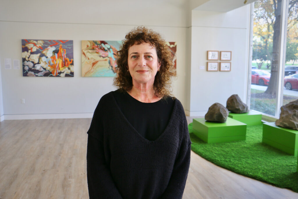Rachel Zimmerman poses for a photo in a gallery