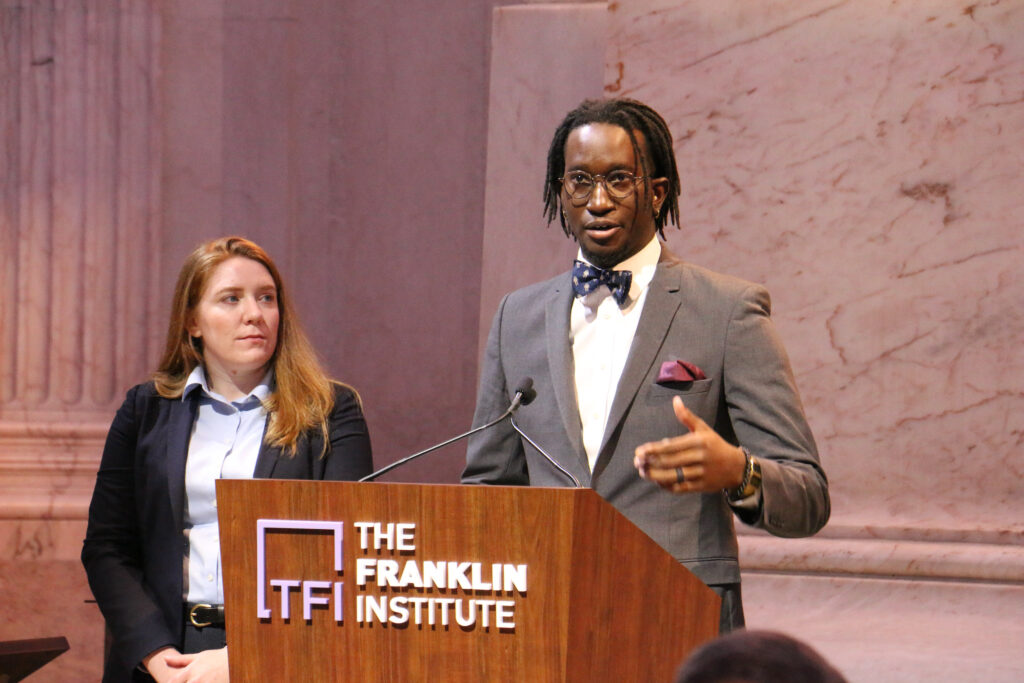 Boeing employees Amanda Ireland and Brandon Burroughs stand behind a podium that reads The Franklin Institute
