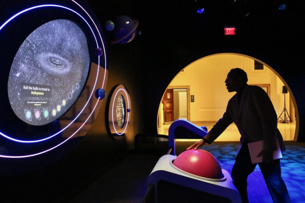 2023 11 02-e lee-derrick pitts-philadelphia franklin institute-wondrous space heliopause Franklin Institute Chief Astronomer Derrick Pitts interacts with one of the institute's exhibits.