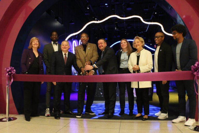 People cut a ribbon in front of the 