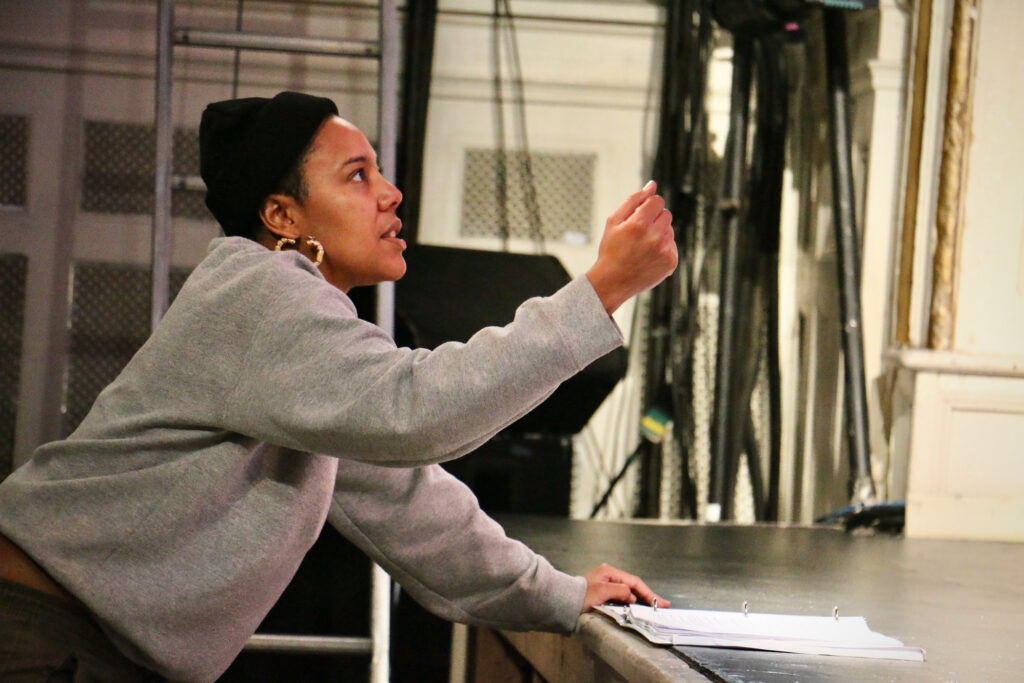 Melanie Cotton gestures as she directs from the stage